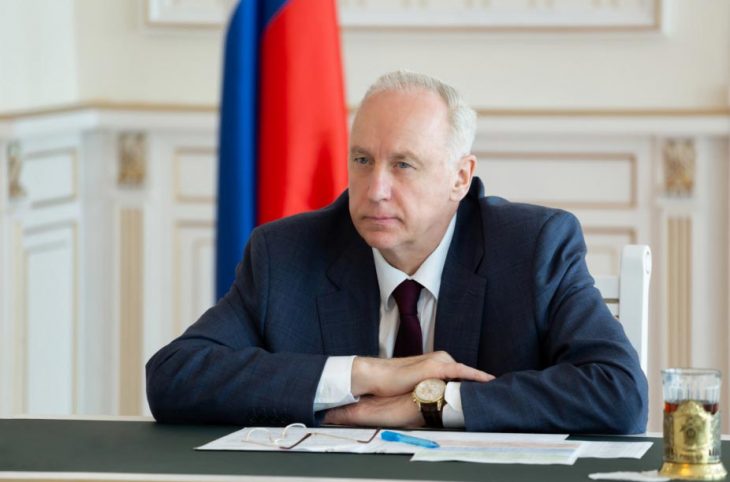 Alexander Bastrykin poses in front of a Russian flag