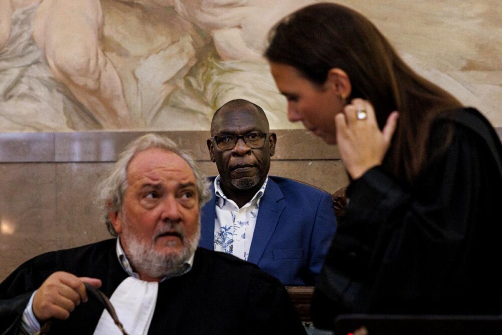 Rwandan Séraphin Twahirwa and his two lawyers, Vincent Lurquin and Juliette Lurquin, at his trial in Belgium. He is on trial for his alleged involvement in the genocide in Rwanda.