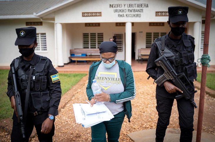 Béatrice Munyenyzezi escorted by police officers in Kigali