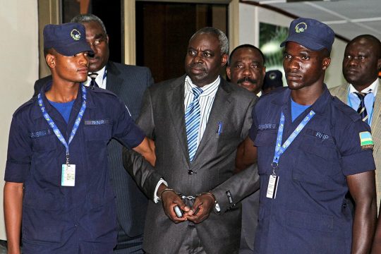 Bernard Munyagishari escorted by police in Kigali, Rwanda