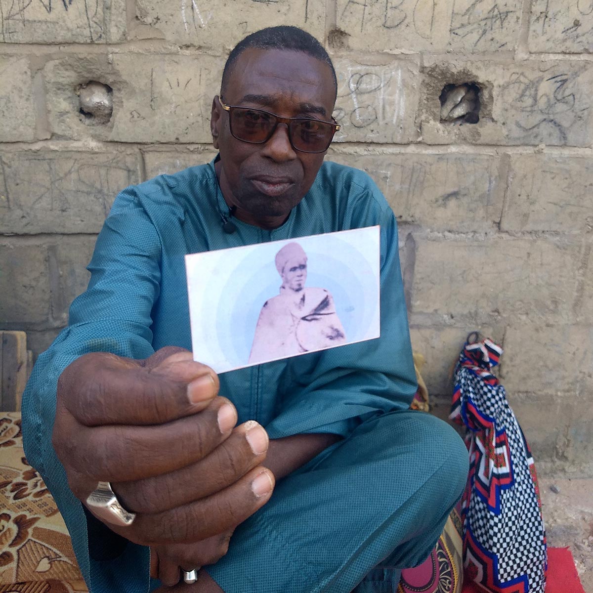 Harouna Daouda Dia shows a photo of his grandfather