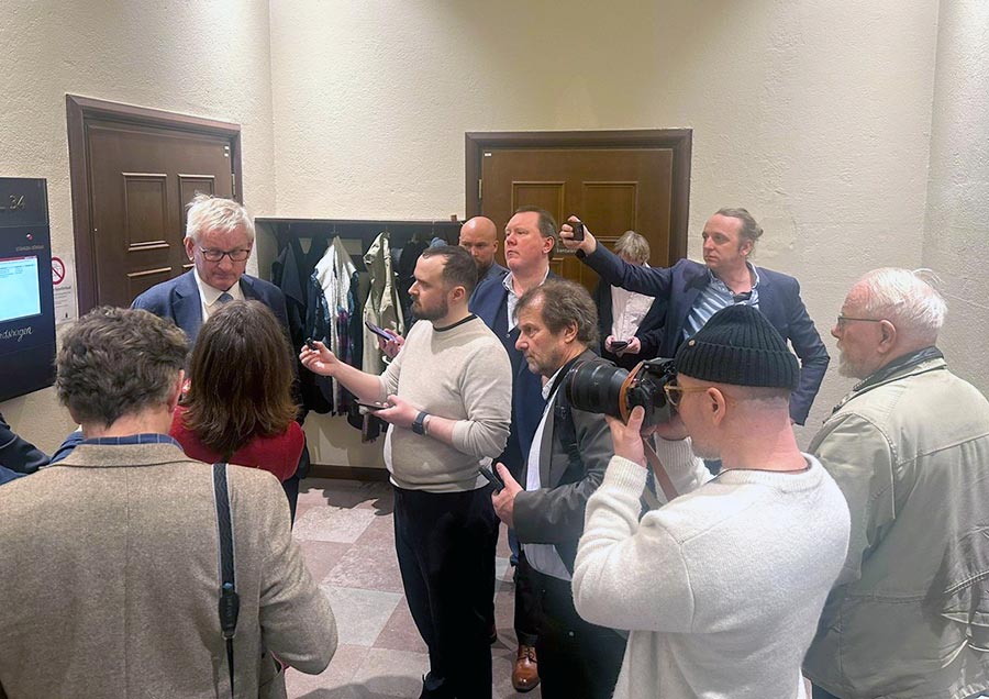 Carl Bildt answers questions from journalists outside the courtroom where the Lundin trial is being held in Sweden.