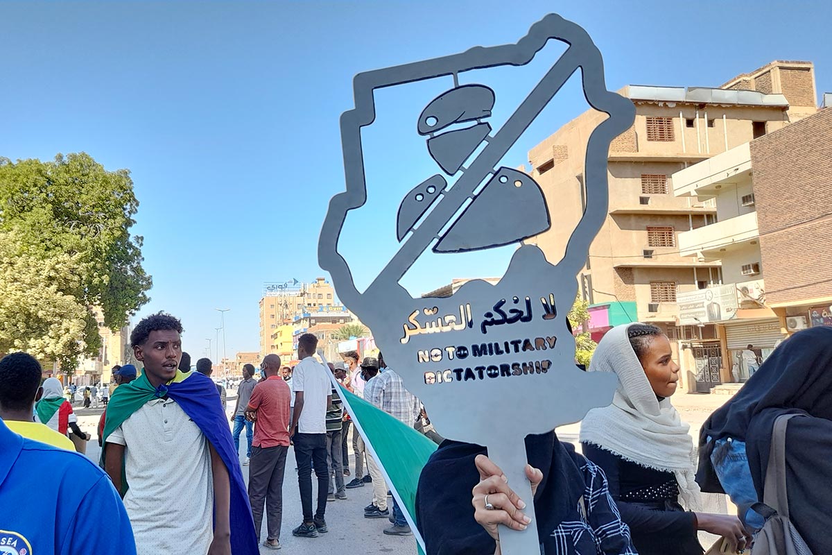 A demonstrator holds a sign that reads 