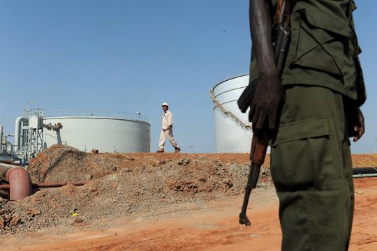 A soldier stands guard outside an oil refinery