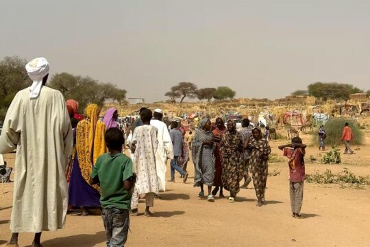 In Sudan, civilians are fleeing a refugee camp in a desert area.