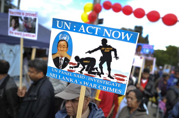 During a demonstration, a sign displays this text message: "UN: act now"