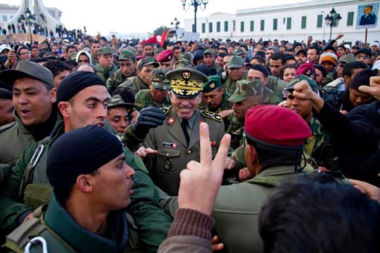 Rachid Ammar surrounded by soldiers and demonstrators