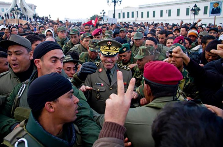 Rachid Ammar surrounded by soldiers and demonstrators