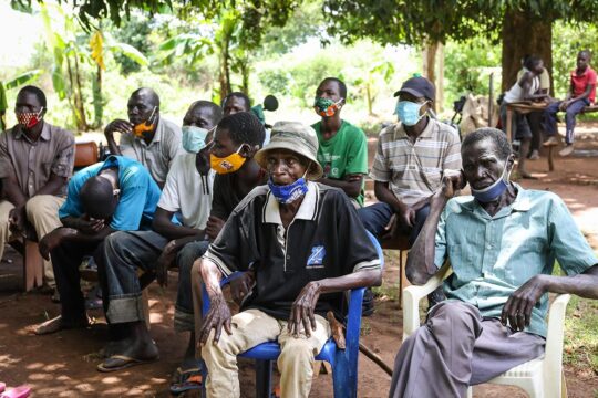 Residents of an Ugandan village listen to the International Criminal Court's (ICC) sentence of Dominic Ongwen, on the radio.