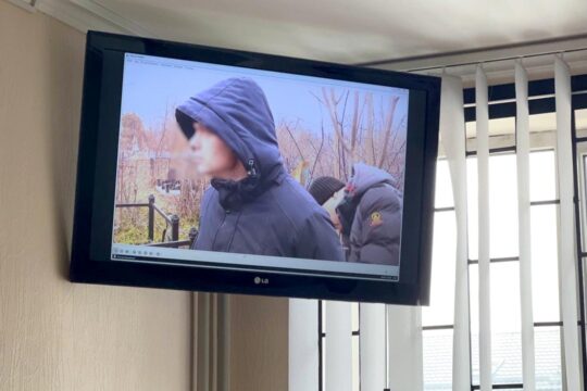Trial in Ukraine of Mykola Fomenko, accused of high treason. He is shown on a television screen during his trial (he was filmed at the time).