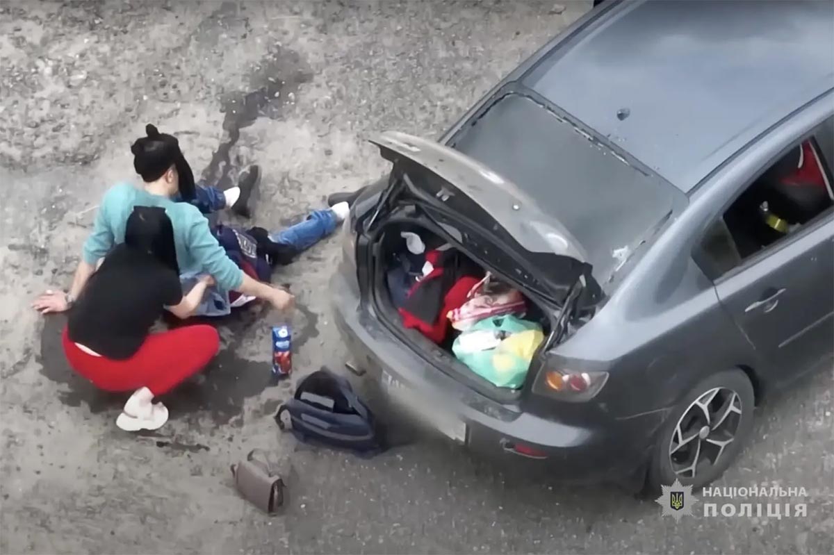 The drone footage shows Valeriya Bohomaz giving first aid to her husband, Andriy, who has suffered head and leg injuries.