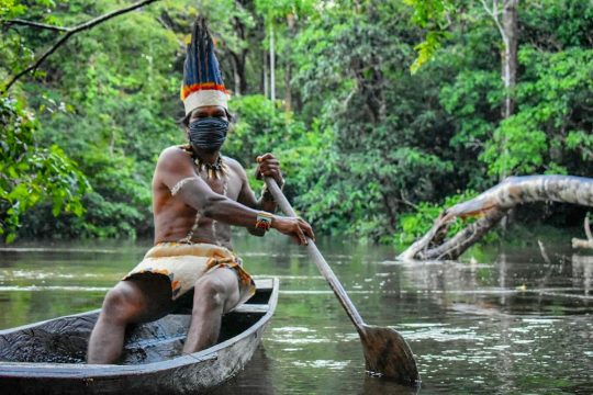A Colombian indigenous navigates on a river