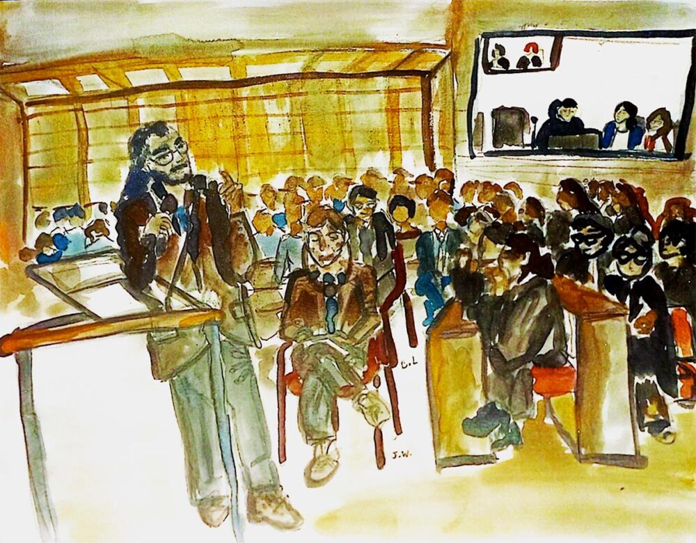 Procès Lafarge à Paris (France) pour des crimes allégués en Syrie incluant des flux financiers vers des organisations terroristes. Illustration : peinture (aquarelle) représentant la salle d'audience où l'on voit une personne debout à la barre et une autre assise à côté, des écouteurs sur les oreilles.